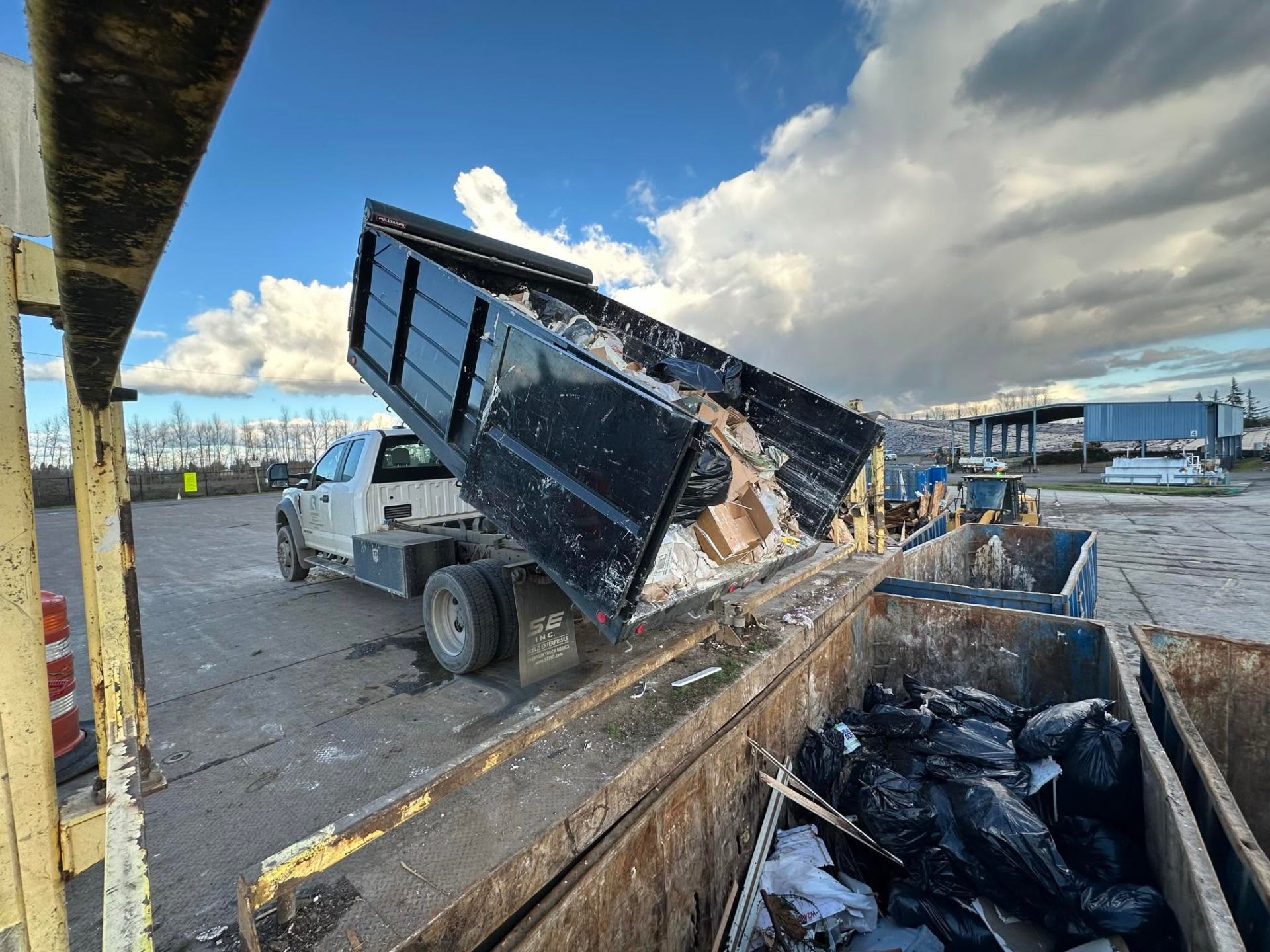 HN Junk Removal truck dumping a load at the transfer station
